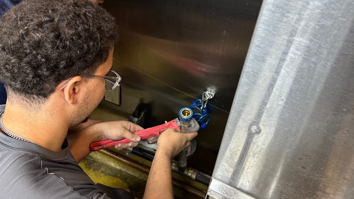 Miami Dade Plumbing crew working valves on a commercial tank