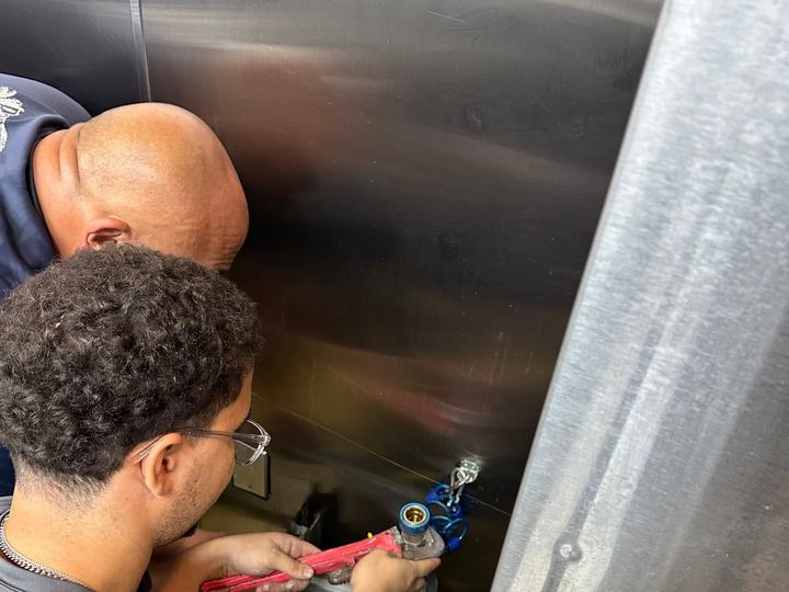 Miami Dade Plumbing crew working valves on a commercial tank
