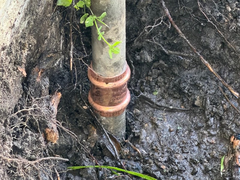 A sewer line coupling set in Miami soil during a Miami Dade Plumbing repair