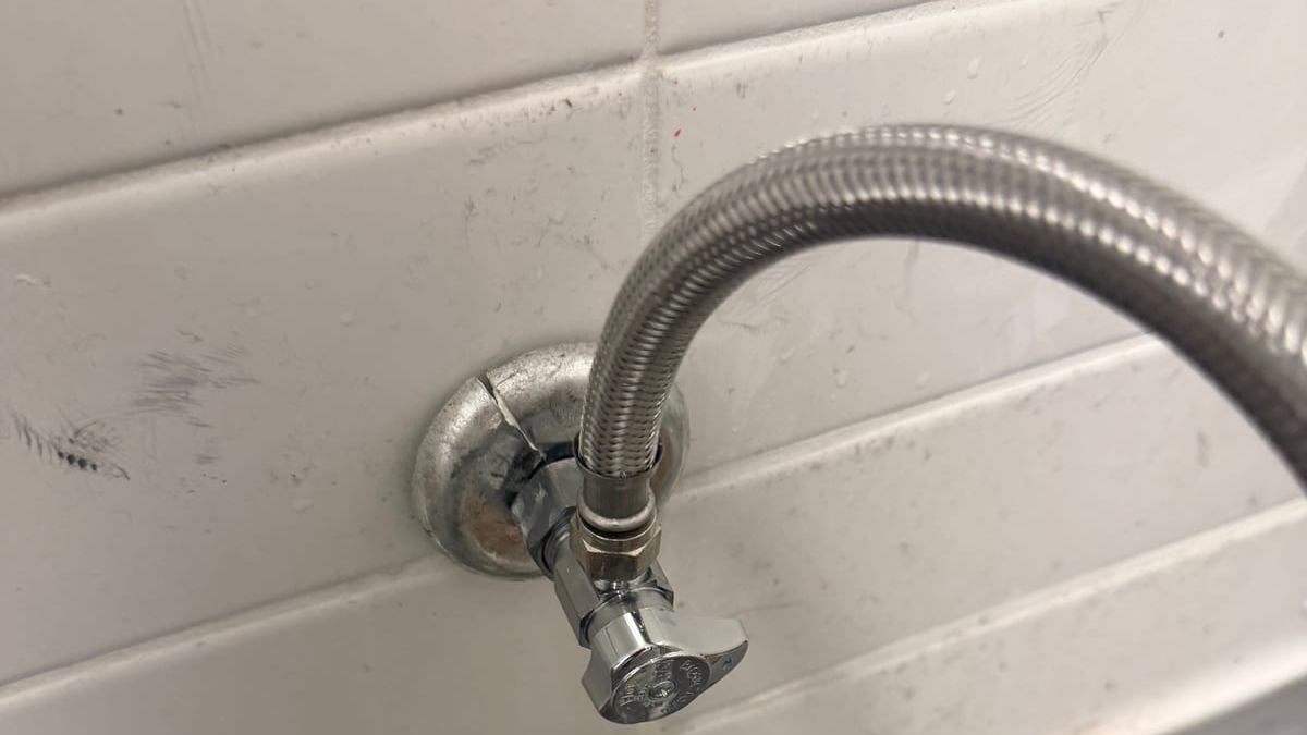 Braided supply lines on a tiled wall during a Miami Dade Plumbing repair