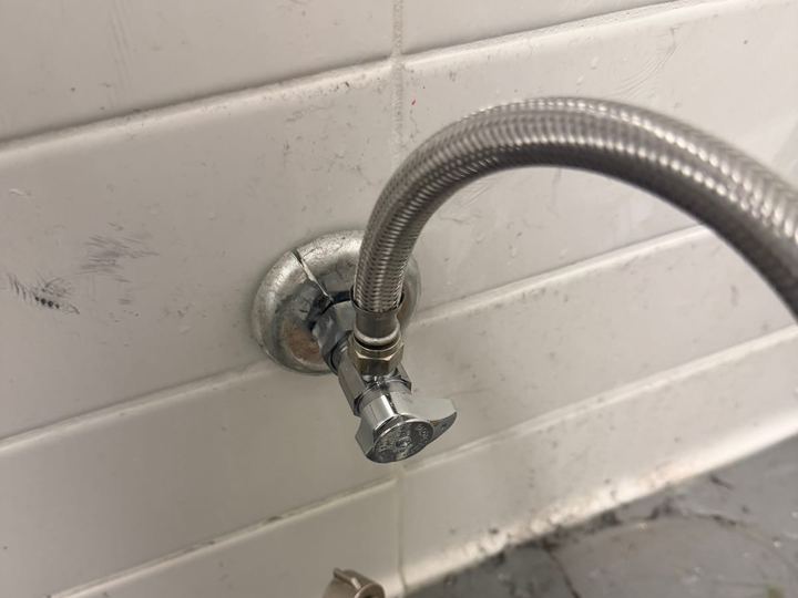 Braided supply lines on a tiled wall during a Miami Dade Plumbing repair