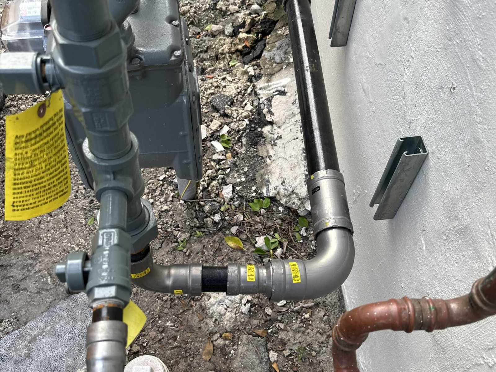 New exterior shutoff and hose bib on a Miami stucco wall