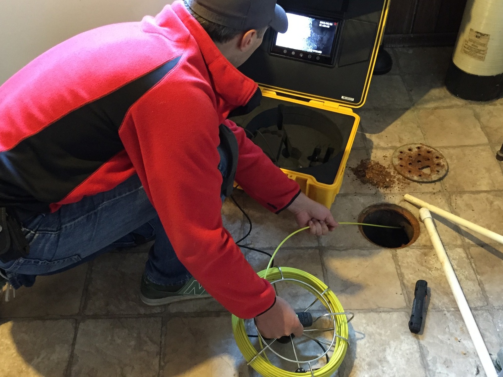 Sewer camera reel going into a cleanout